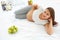 Pregnant Woman lying on the Bed with fresh Apples. Healthy Food