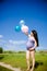 Pregnant woman on a meadow with blue sky