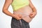 Pregnant woman is measuring belly with tape meter