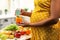 Pregnant woman measuring nitrates in a sweet pepper.