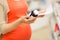 Pregnant woman with medication jar at pharmacy