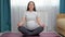 Pregnant woman meditates on mat taking care of wellness