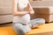 Pregnant woman meditating while sitting in yoga position. Meditating on maternity Pregnancy Yoga and Fitness concept at
