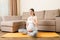 Pregnant woman meditating while sitting in yoga position. Meditating on maternity Pregnancy Yoga and Fitness concept at