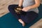 Pregnant woman meditating on yoga mat with a Tibetan singing bowl