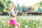 Pregnant woman with mehendi pattern on belly blows on dandelion