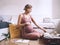 Pregnant woman packing bag for maternity hospital, making notes, checking list in diary. Expectant mother with suitcase of baby