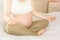 Pregnant woman peacefully meditating on a bed