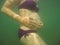 Pregnant woman performing underwater exercise