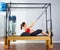 Pregnant woman pilates reformer roll up exercise