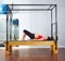 Pregnant woman pilates reformer shoulder bridge