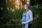 Pregnant woman profile in forest at sunset