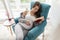 Pregnant woman reading a book at home