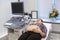 Pregnant woman is ready for procedure of ultrasonography, lying back on therapy bed