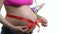 Pregnant woman with red ribbon and festive hat on her stomach