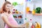 Pregnant woman and refrigerator with health food