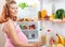 Pregnant woman and refrigerator with health food vegetables