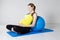 Pregnant woman relaxing against fitness ball
