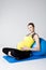 Pregnant woman relaxing against fitness ball