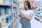 Pregnant woman shopping baby formula. Young pregnant woman buying infant baby formula milk on supermarket background