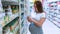 Pregnant woman shopping baby formula. Young pregnant woman buying infant baby formula milk on supermarket background