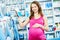 Pregnant woman shopping at cosmetic shop