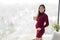 Pregnant woman showing 25 weeks pregnancy bump for maternity photoshoot holding wooden blocks sign happy. Asian