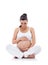 Pregnant woman sitting and practicing yoga