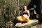 Pregnant woman sitting on stone in easy yoga pose