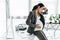 Pregnant woman sitting on table, holding belly and enduring pain