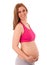 Pregnant woman smiling and holding tummy