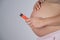 A pregnant woman smokes a vape. A girl holds an electronic cigarette against the background of her bare tummy. Copy