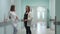 A pregnant woman standing in the corridor of the transplant center communicates with a doctor in a white dressing gown