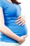 Pregnant woman with stomach pain touching belly, aches in pregnancy and risk of miscarriage
