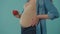 A pregnant woman strokes her big belly and holds a red heart figure. Bloated belly of a pregnant woman in the studio on