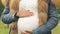 Pregnant woman stroking belly, worried about health of child, prenatal care