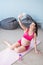 A pregnant woman takes a selfie on a yoga mat. Caucasian expectant mother is photographed on a smartphone during Pilates