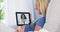 Pregnant woman talking to her doctor on tablet