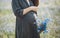 pregnant woman tenderness health outside field cornflowers