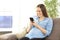 Pregnant woman texting with a smart phone