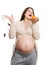 Pregnant woman throwing away medicine and choosing fruits