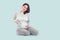 Pregnant Woman touching her belly. Pregnant middle aged mother`s hands caressing her tummy. Healthy Pregnancy concept