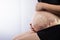 Pregnant woman touching her big belly. Close up. Pregnant woman expecting baby