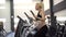 Pregnant Woman training elliptical trainer in gym Cardio exercises on Running simulator