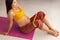 Pregnant woman training legs doing prenatal pregnancy clamshell sitting hip exercise with resistance bands preparing for