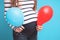 Pregnant woman tries to guess the boy or girl. Balloons as symbol of boy and girl.