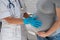 Pregnant woman visiting a doctor. Elderly Caucasian female gynecologist holds hands on the tummy of a pregnant patient.