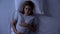 Pregnant woman waking at night in bed, pregnancy difficulties, insomnia problem