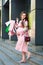 A pregnant woman walking with packages near a shopping center