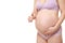 Pregnant woman wearing purple underwear with thumbs up gesture